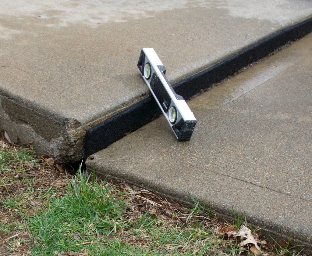 An image depicting a sunken and settled concrete slab. Polypier concrete leveling can fix this.