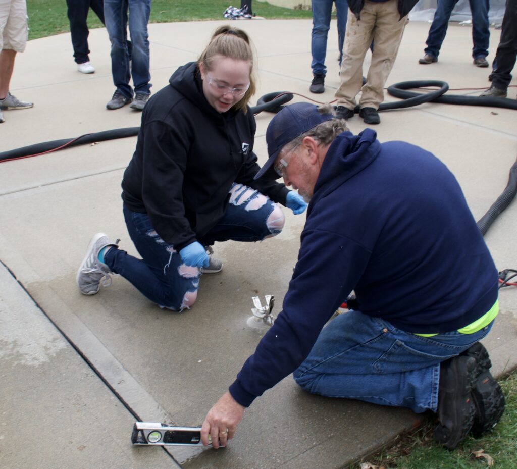 Using a level to show that this concrete driveway has been leveled with PolyPier.
