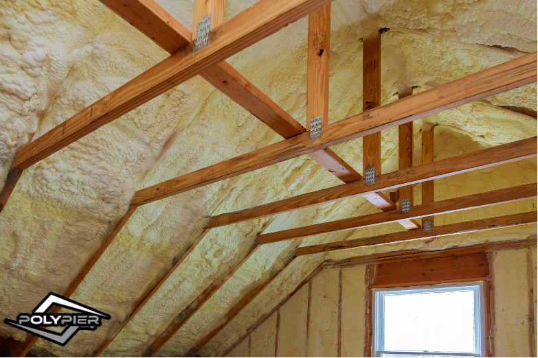 Attic ceiling with spray foam insulation applied.